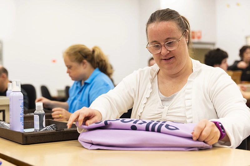 A Packforce supported employment team member working on packing a showbag
