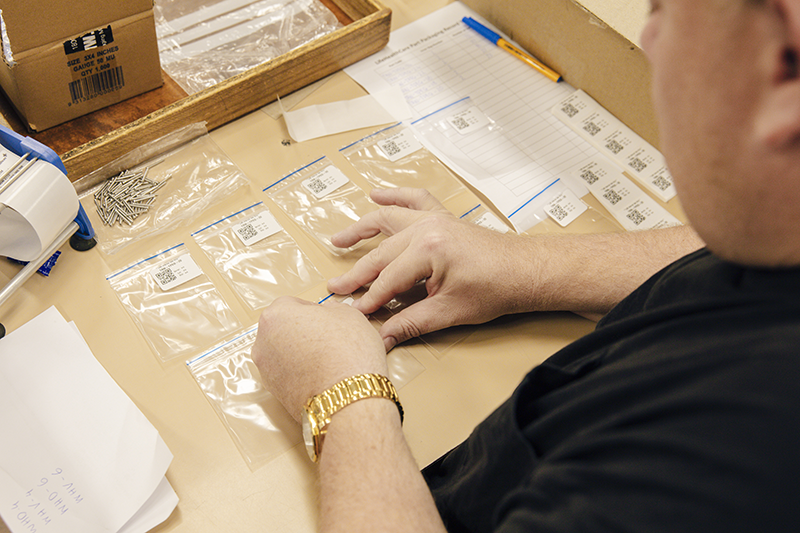 Close up of a team member working on a labelling job at Packforce